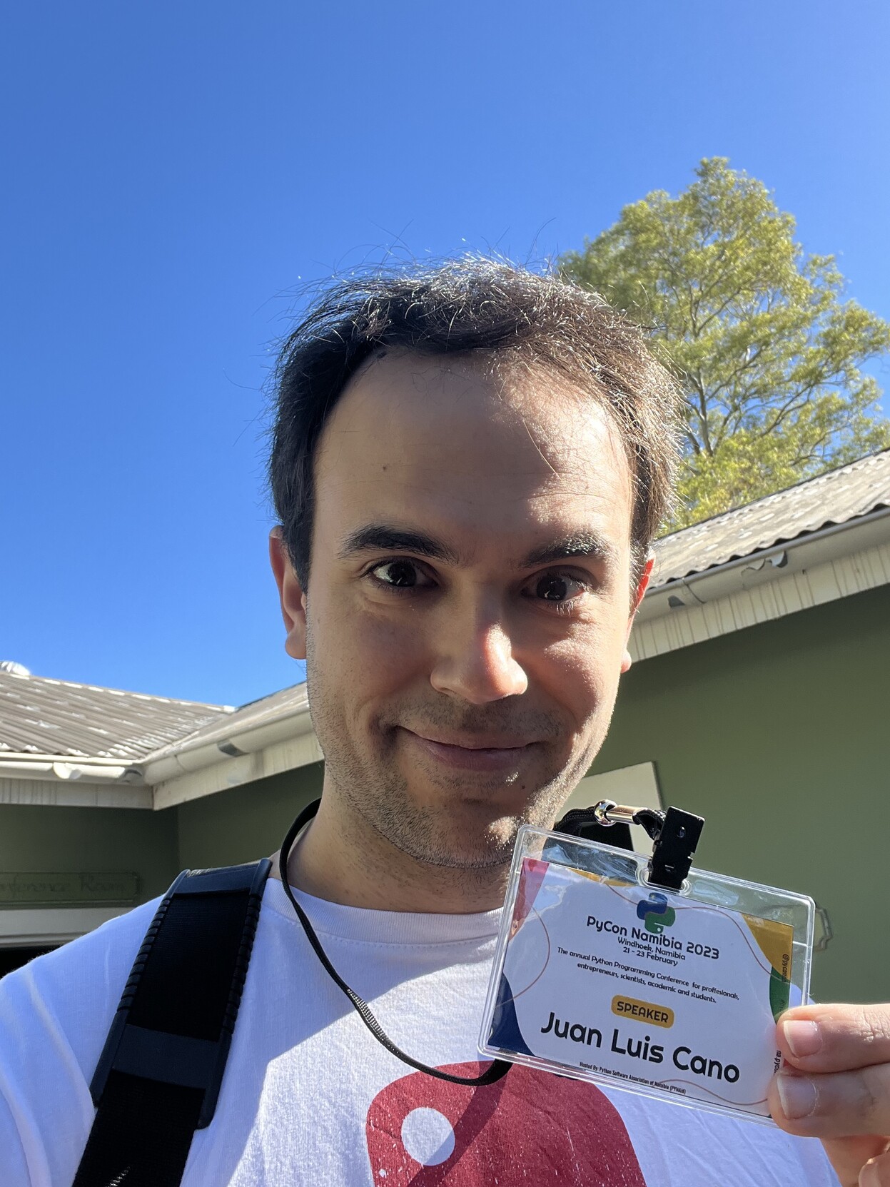 Juan Luis looking at camera with his PyCon Namibia 2023 badge