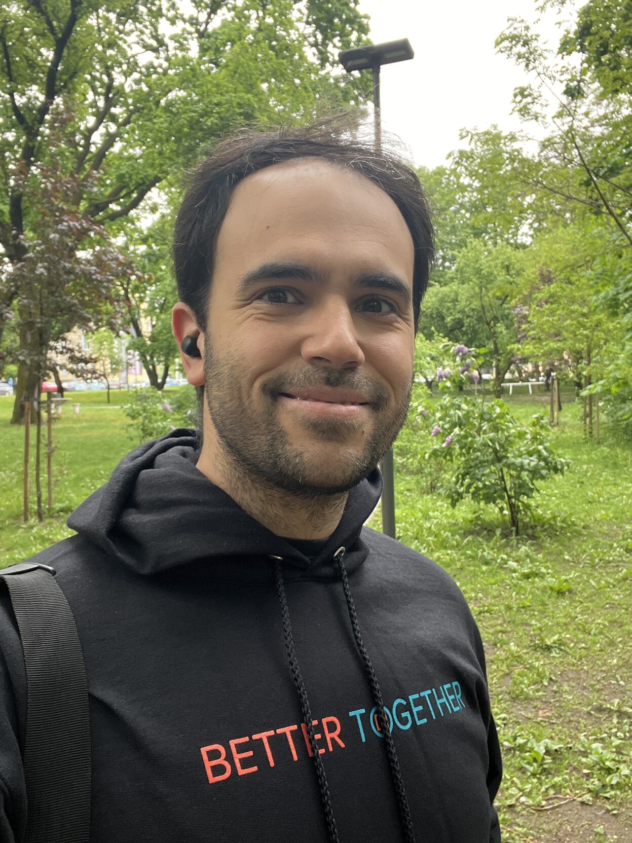 Photo of young man wearing a hoodie with the letters “better together”