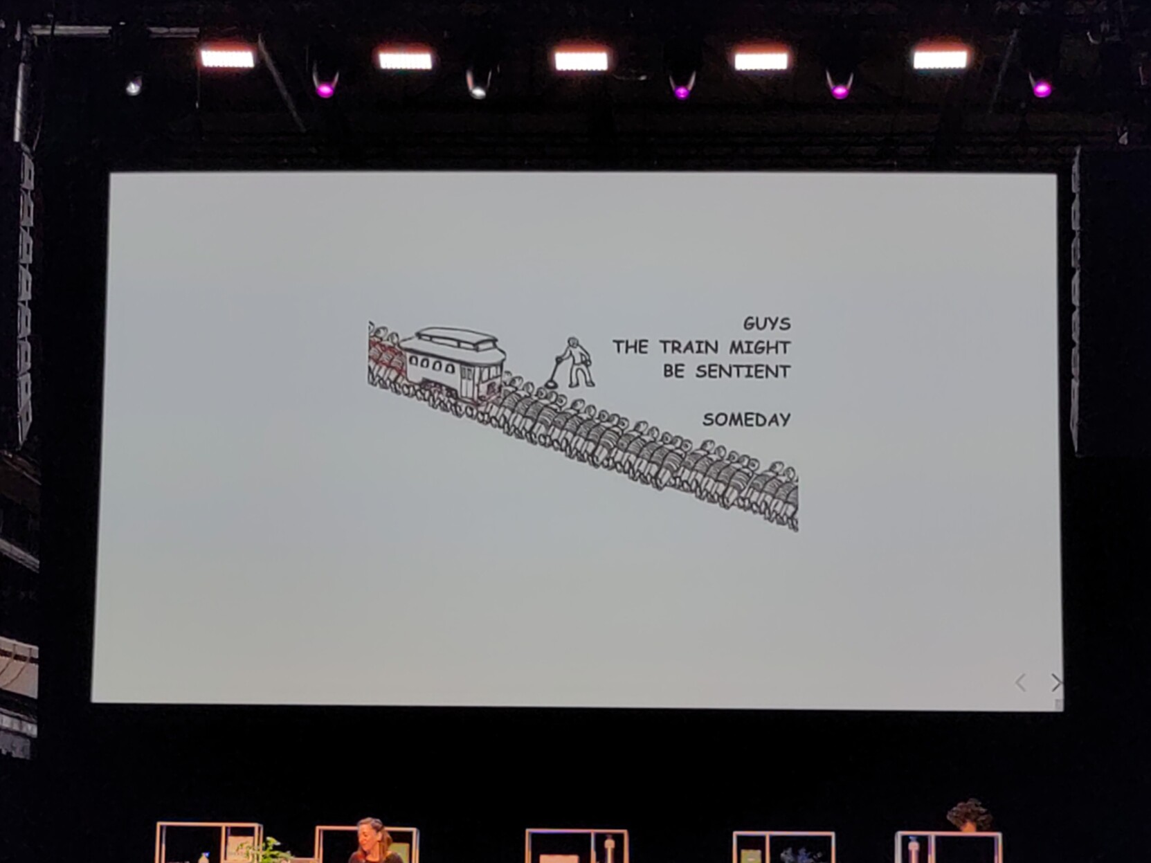 Parody of the trolley problem, with the trolley slaughtering a line of people tied to the rails and an operator saying "guys the train might be sentient someday"