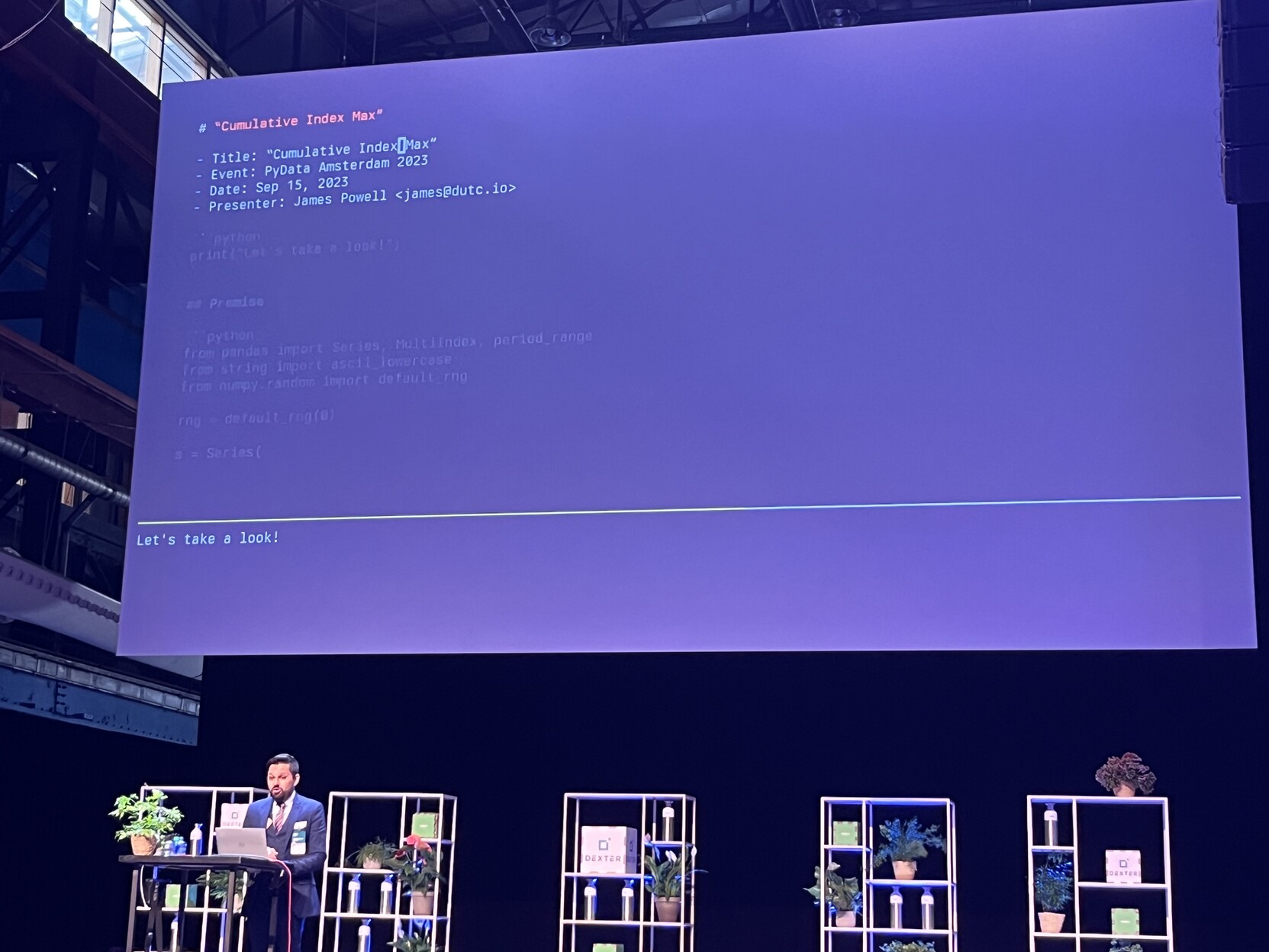 Photo of James Powell under a giant screen